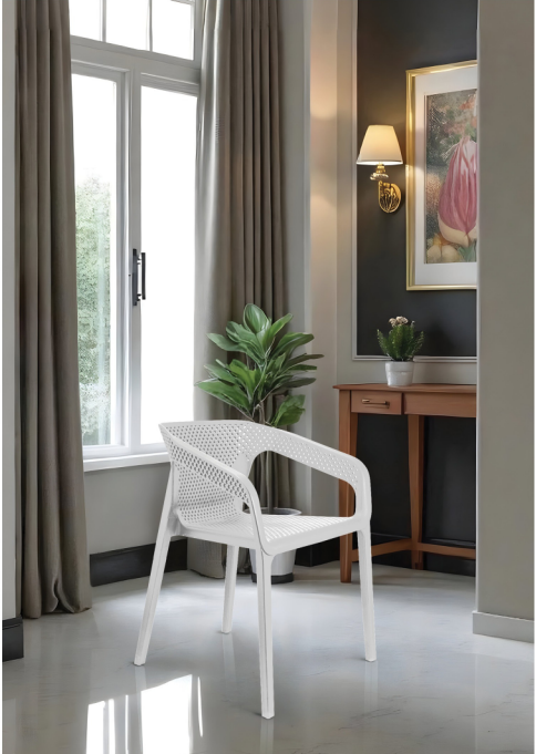 Alt text: CUBE.PNG	White Cube perforated cafe armchair in a bright room