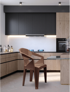 Alt text: HEXA.PNG	Brown Hexa stackable cafe chair with arms in a modern kitchen