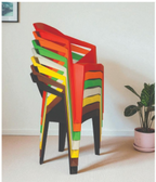 Alt text: HEXA (1).PNG	Hexa cafe chairs stacked in red, orange, yellow and green